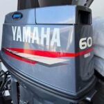 Yamaha 60HP 2 Stroke oil injected outboard mounted on fishing boat