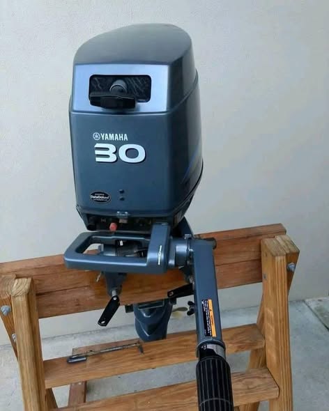 Yamaha 30HP 2 Stroke outboard motor mounted on small fishing boat