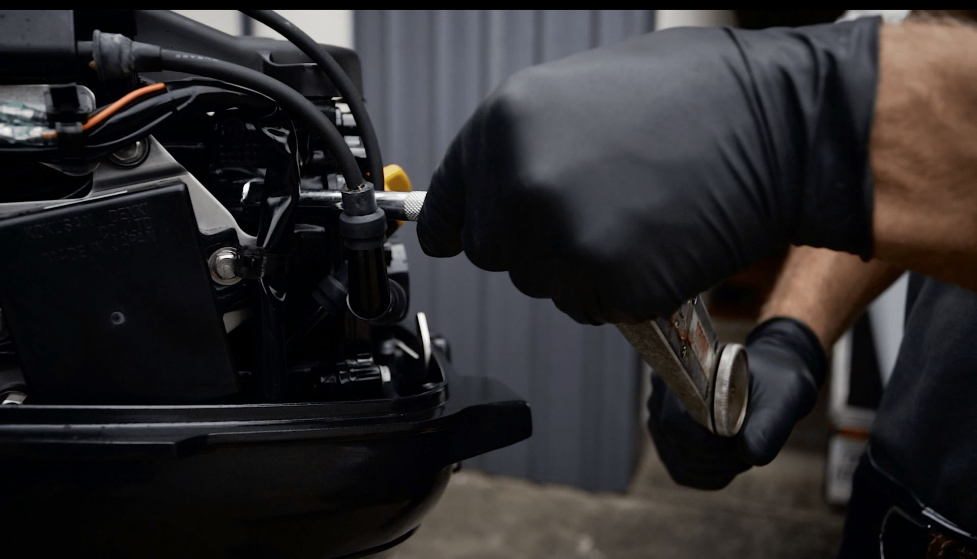 Marine technician servicing boat outboard engine in Australia workshop